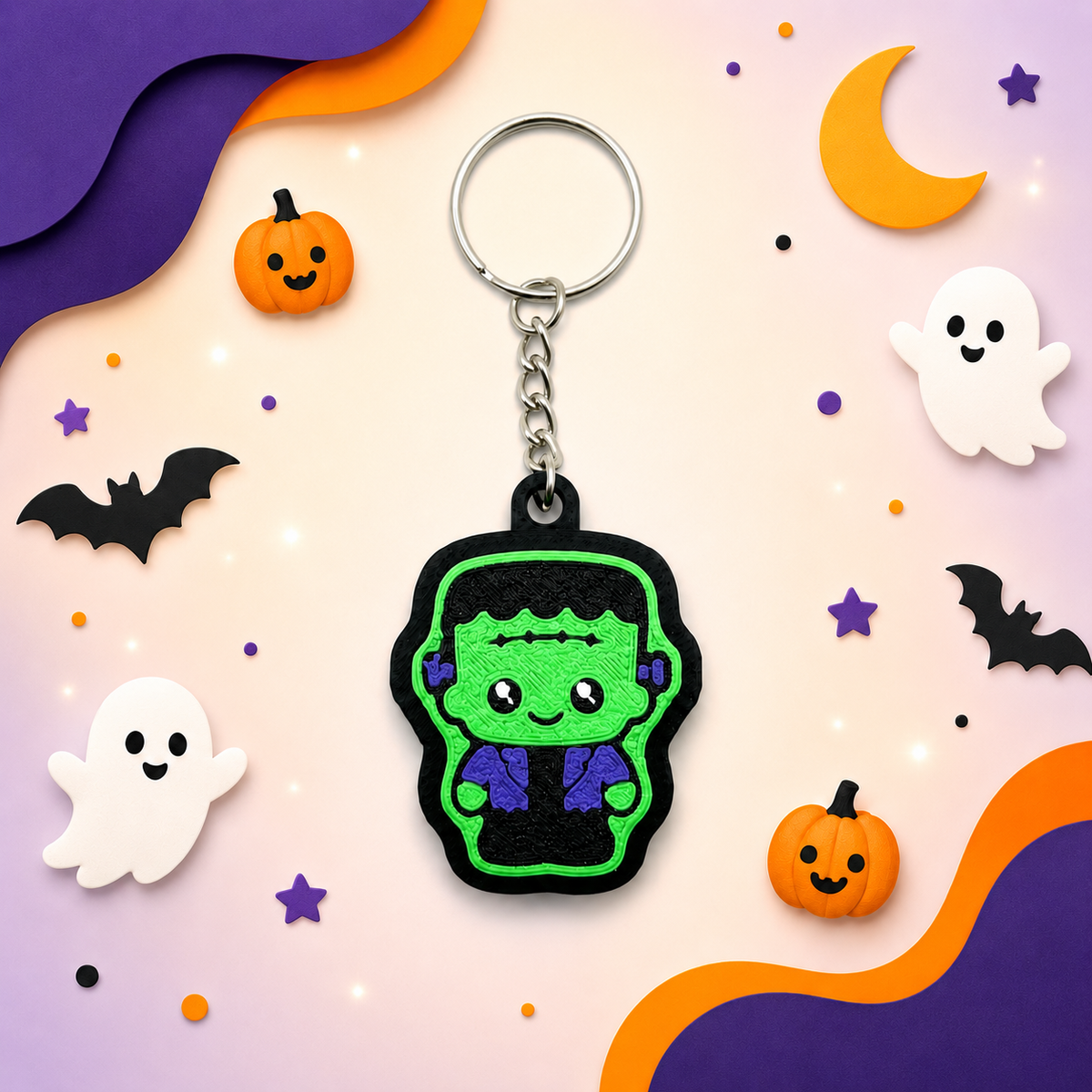 Green Frankenstein fidget clicker keychain displayed on a Halloween background with ghosts, bats, pumpkins, stars and a crescent moon.