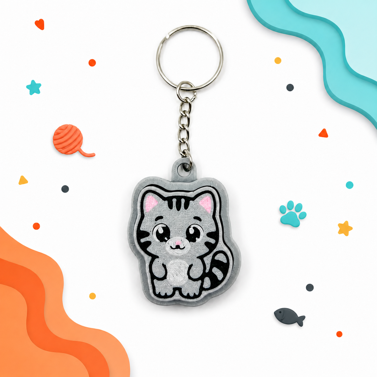 Gray tabby cat fidget clicker keychain with colorful cat-themed background accents